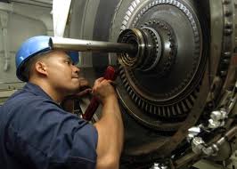 Mechanic servicing a jet engine