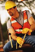 Heavy equipment operator in a hard hat and safety vest